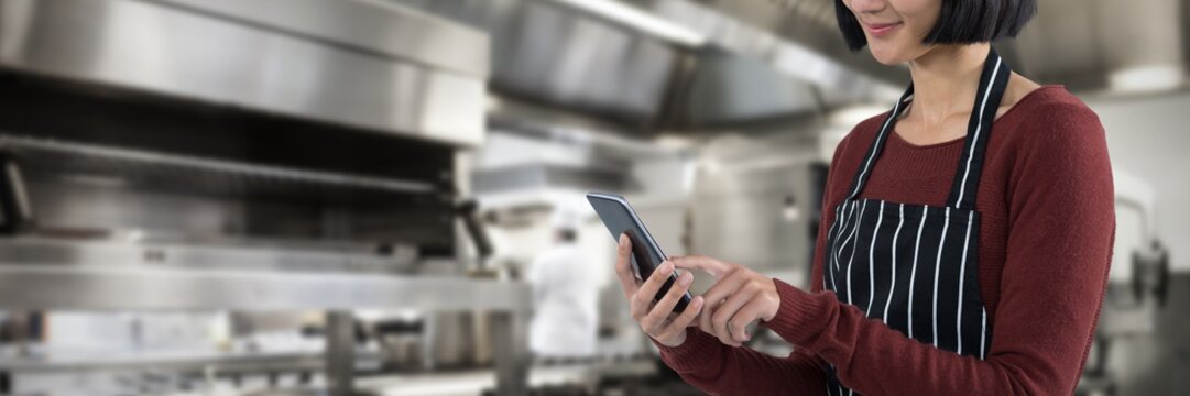 Composite image of waitress using mobile phone against white
