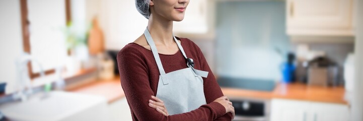 Composite image of thoughtful female chef standing with arms