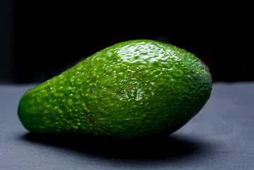 Ripe avakado on a black  slate board