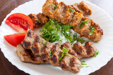 Grilled Lula kebab in a white dish
