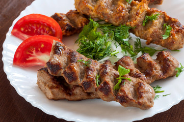 Grilled Lula kebab in a white dish