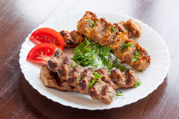 Grilled Lula kebab in a white dish