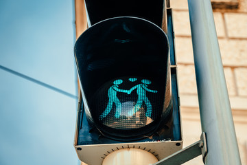 Traffic lights with men holding hands and a heart between their heads in Vienna