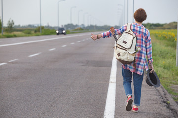  girl with a guitar hitch-hiking