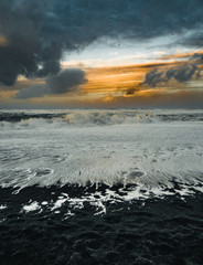 Sunrise at famous Black Sand Beach Reynisfjara in Iceland. Windy Morning. Ocean Waves. Colorful Sky. Morning Sunset.