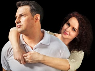 Fototapeta na wymiar Portrait of Wife Embracing Husband who is Looking Sideways