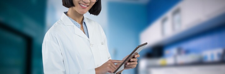 Composite image of doctor using digital tablet against white