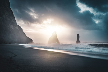 Sunrise at famous Black Sand Beach Reynisfjara in Iceland. Windy Morning. Ocean Waves. Colorful...