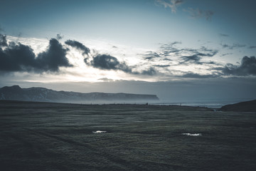 Sunrise at famous Black Sand Beach Reynisfjara in Iceland. Windy Morning. Ocean Waves. Colorful Sky. Morning Sunset.
