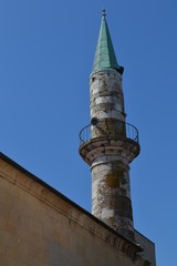 Minaret of an old traditional mosque in Eastern Europe