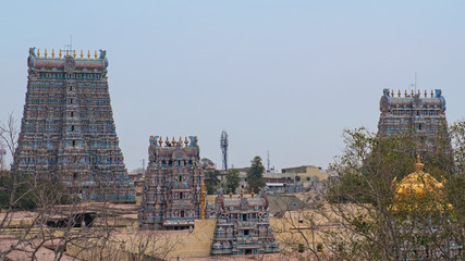 Some of the 14 Gopurams, or gateway towers, of the Meenakshi temple complex covering 45 acres in the city of Madurai. The golden dome covers the inner sanctum, or Vimana, of the temple