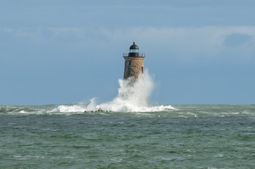 Giant Wave Surrounds Stone Lighthouse Tower in Maine