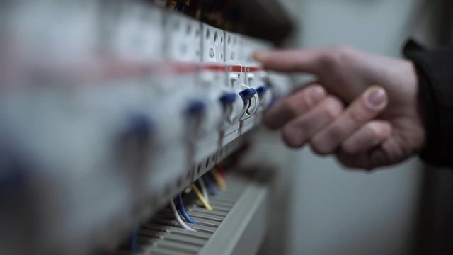 The electrician switches on the circuit breakers and starts the system