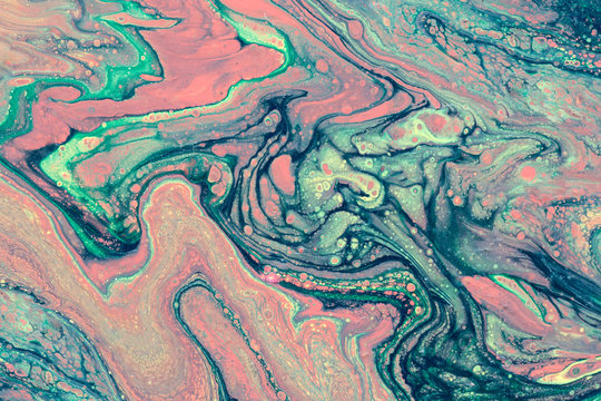Сreative abstract marbling textured background. Mixing red, green and blue paints. Handmade surface. Liquid paint. © torook