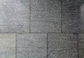 Fototapeta premium Texture of black or dark gray granite. Geometric smooth boundaries. Treated stone.