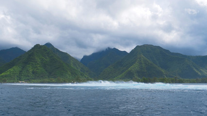 Cloudy sky clears up after an intense tropical storm on lush remote island.