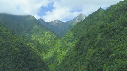 AERIAL: Breathtaking aerial view of the mountains towering over empty valley.