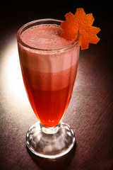 three-layer cocktail in a faceted glass on a dark table