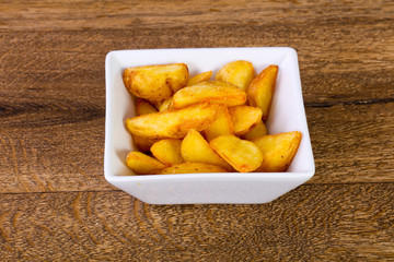 Rustic potato over wooden background