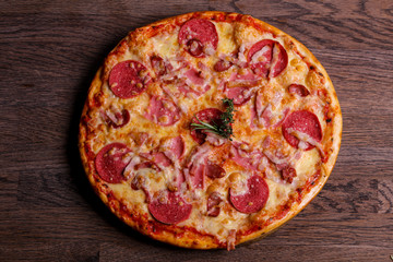 Pizza with ham and sausages