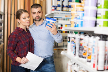 couple is choosing paint with shop list