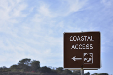 coastal access traffic street sign beach sun ocean water