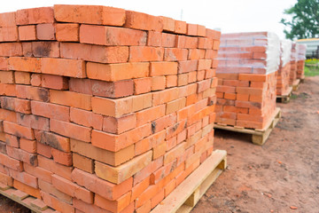 The bricks are stacked on wooden pallets and prepared for sale. Clay brick is an ecological...