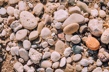 Coast. Pebble beach. Background for travel agencies. Holidays in hot countries. Sand, stones and the sea. Side, Turkey.