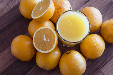 Orangesaft im glas mit ganz vielen Orangen