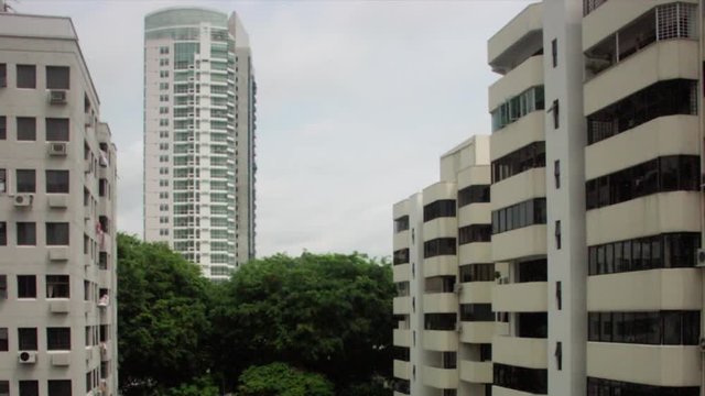 Timelapse tilt down of apartment buildings to swimming pool Singapore Asia