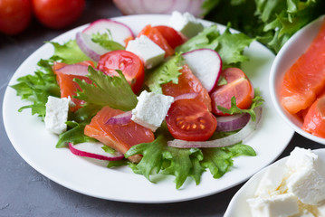 Fresh salad from salmon and vegetables.