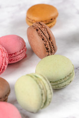 Colorful macaroons on stone table. Sweet macarons