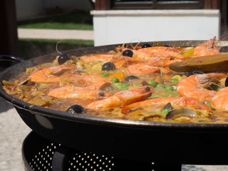 Traditional Spanish paella with seafood and chicken. Prepared in large pan