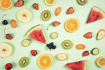 Sliced assorted fruits on background