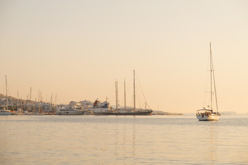 Fototapeta na wymiar Yachts and boats in sunset near Parikia port, Paros island, Greece