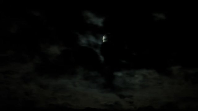 Timelapse of moon behind crisscrossing cloud layers