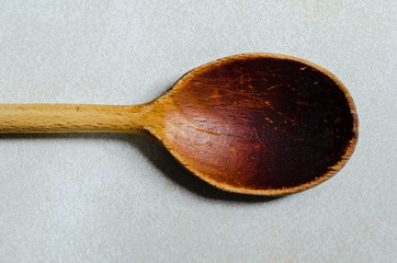 horizontal single weathered wooden mixing spoon