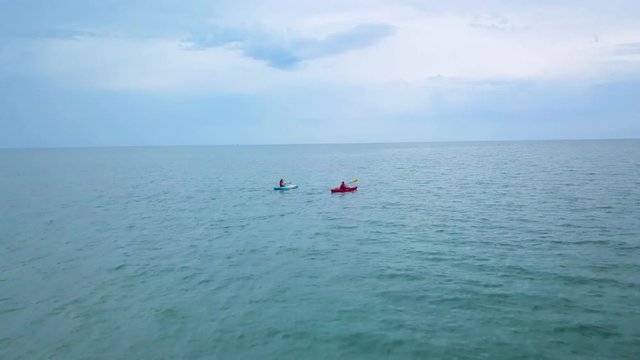 Drone passes kayaks on Lake Erie on cloudy day