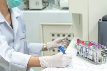 scientist doing testing and record blood information in laboratory for education