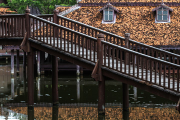 Fototapeta na wymiar Peaceful thai floating architecture with traditional wooden house and bridge in Ancient City, Thailand, Asia
