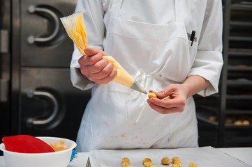 Chef piping filling into pastry