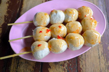 Pork rounded and then cooked with boiling and then sprinkle with sweet spicy sauce.