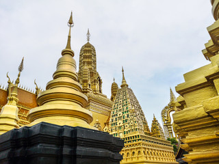 Obraz premium Golden buddhist temple with stupa, replica of an ancient thai temple in Ancient City at Muang Boran in Thailand, Buddhavas of the Substanceless Universe