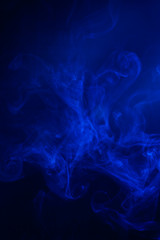 Blue smoke on black background.