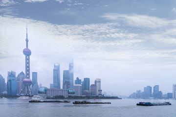 Fototapeta premium Shanghai Financial Center and modern skyscraper city in misty sunrise behind pollution haze, view from the bund in Shanghai, China. vintage picture style