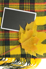 Autumn . empty chalkboard , maple leaf on a yellow checkered scarf isolated on white background. top view, copy space. Autumn season. Autumn time
