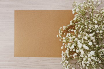 paper craft and dried flowers on wooden background