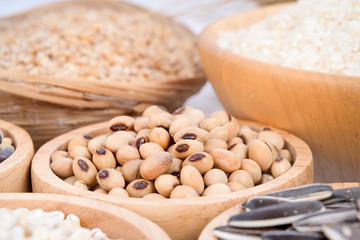 Cereal grains , seeds, beans on wooden background