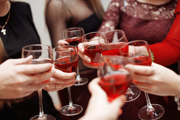 Cheers. Wine tasting event by happy people concept. Women toasting with glasses of red wine on party