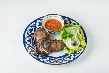 meat in a beautiful plate with lettuce and onion
